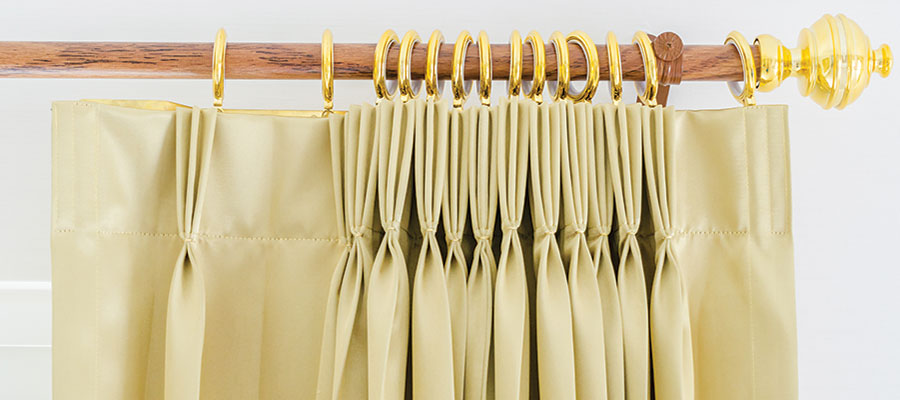 Pleated drapes on a curtain rod