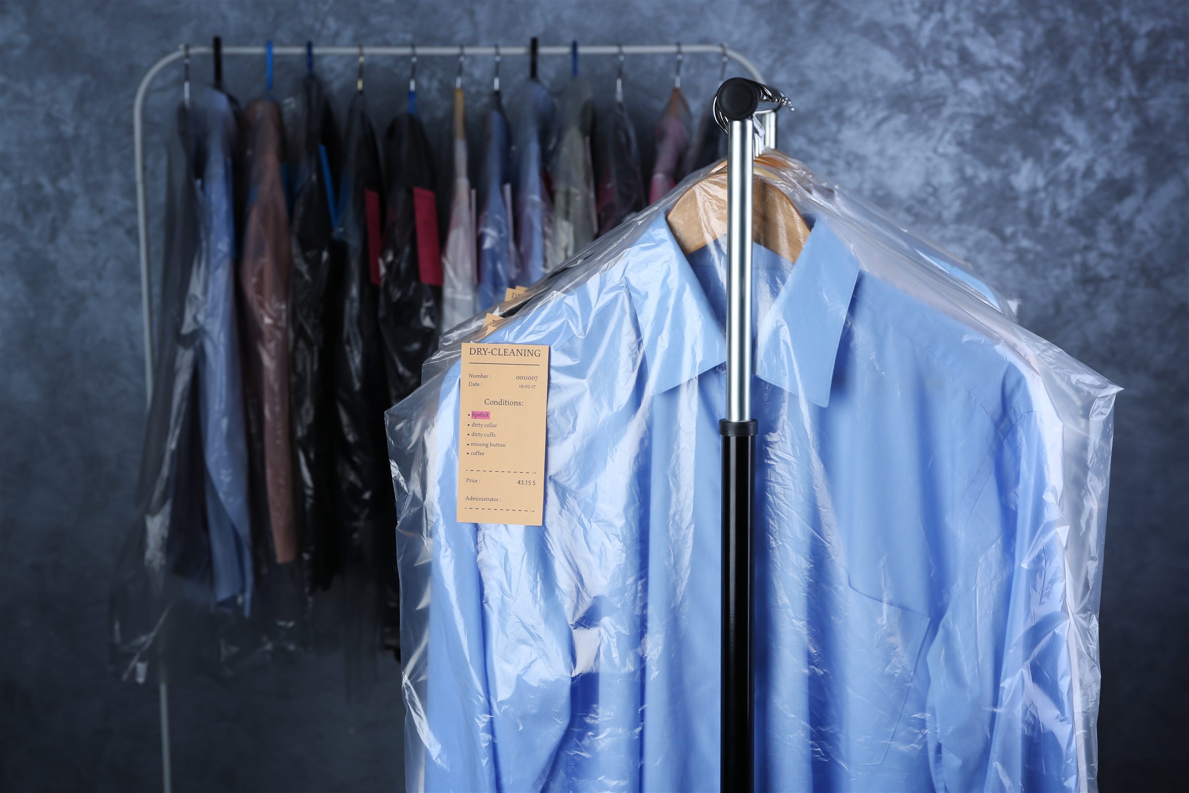 Pressed blue shirt in a garment bag ready for pick-up