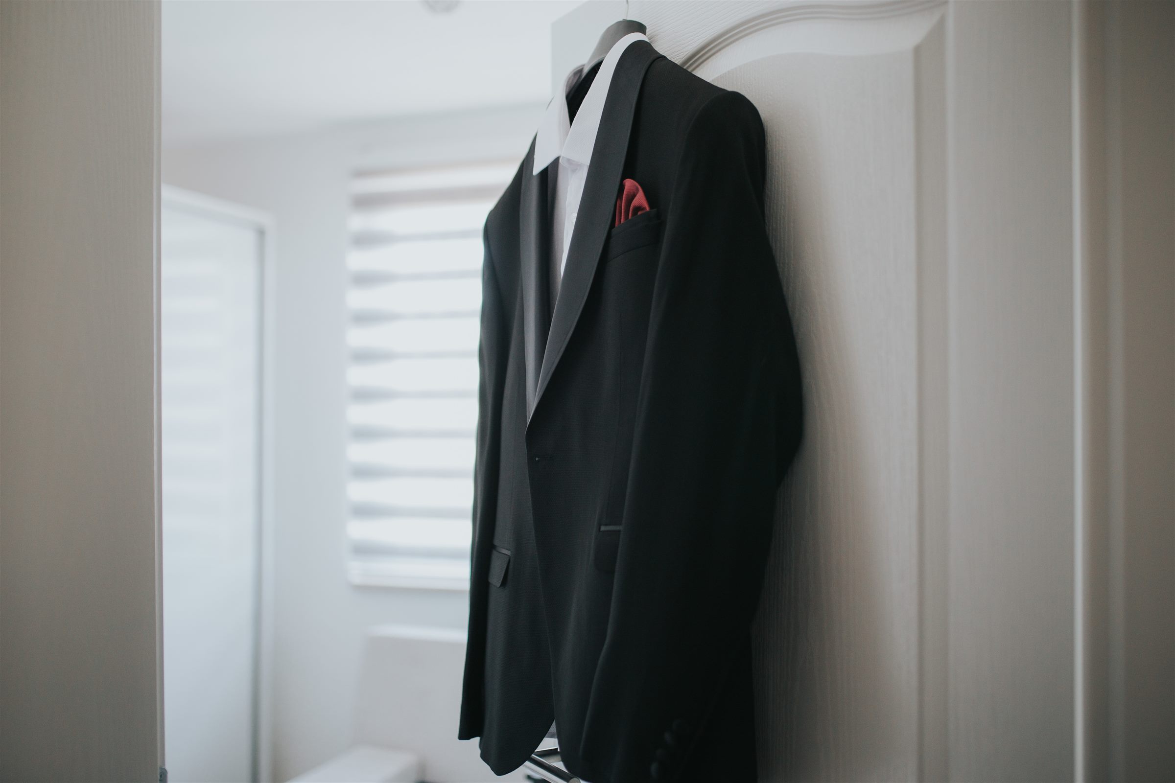 Black suit and white shirt on a hanger