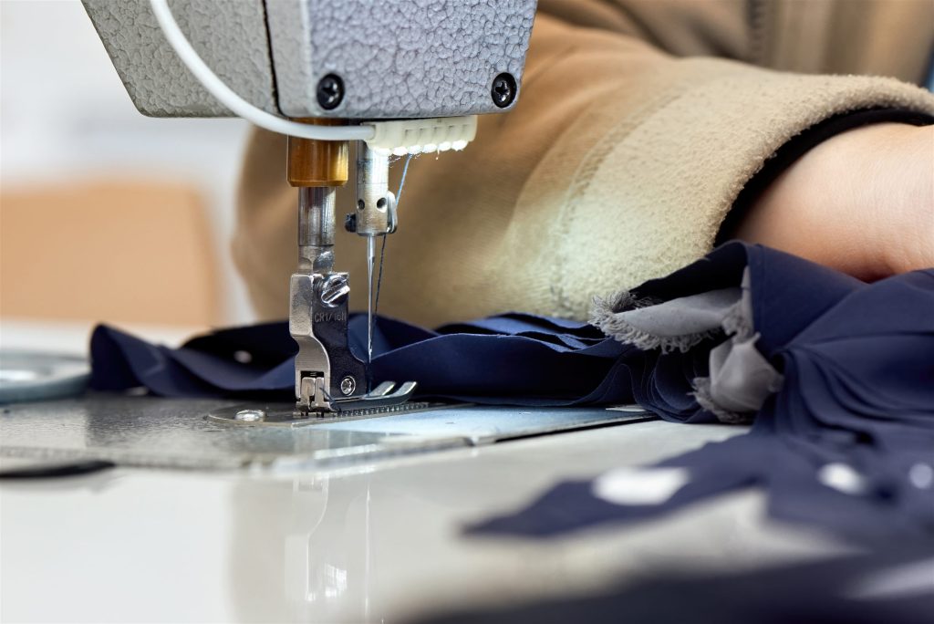 Tailor sewing a garment on a sewing machine