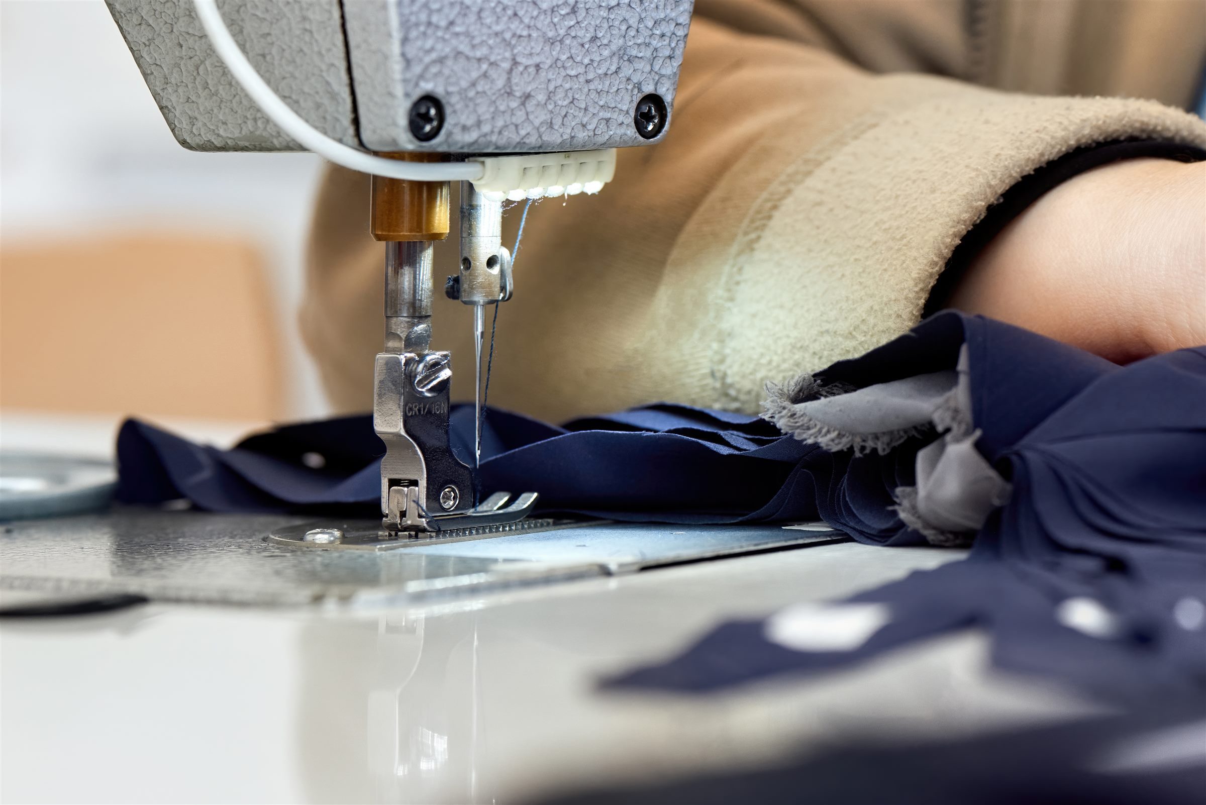 Tailor sewing a garment on a sewing machine